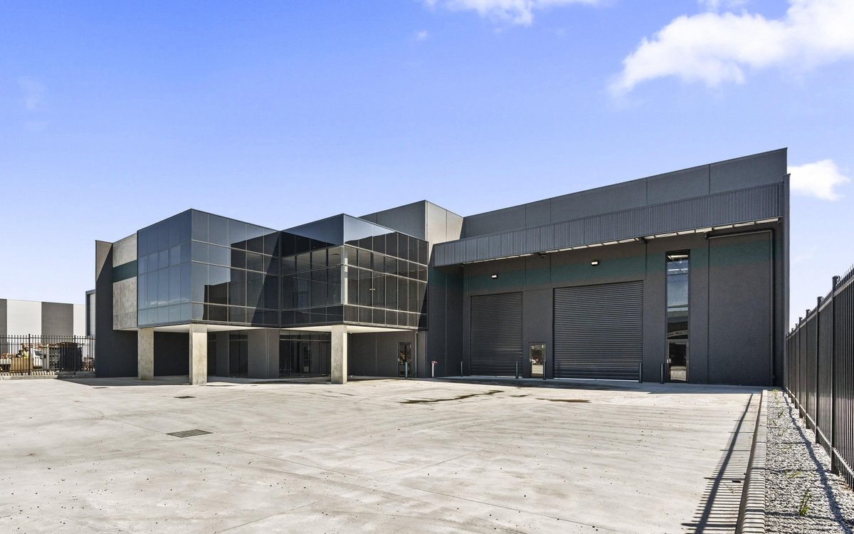 Industrial warehouse with a glass front office and roller doors
